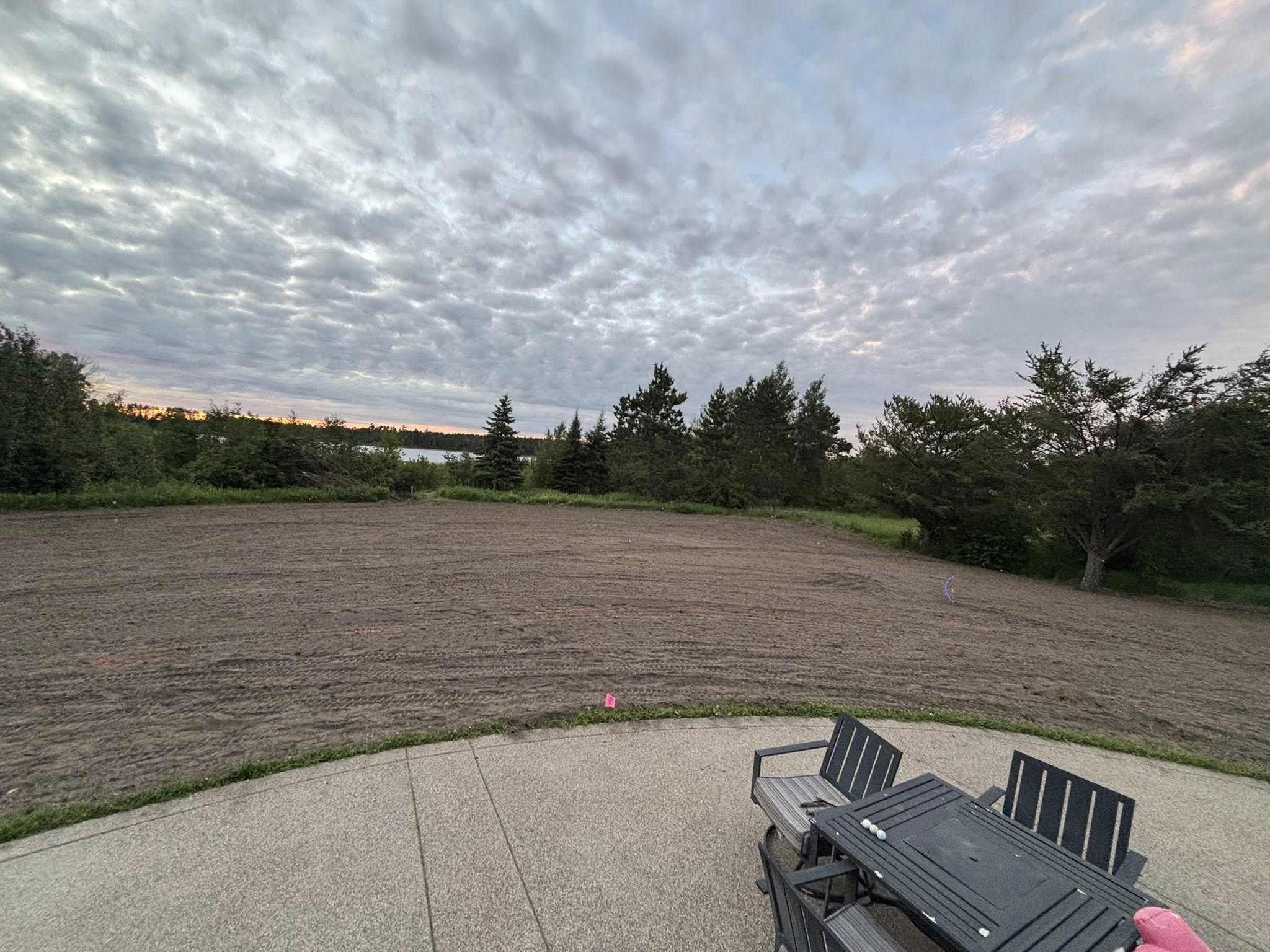 Graded yard with tracked dirt pattern at sunset